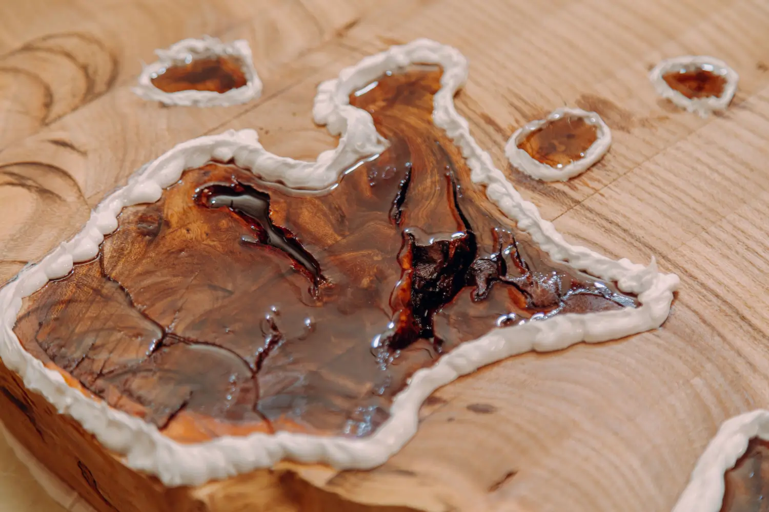 Resin-filled wood slice with white sealant border.