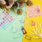 Colorful resin earrings and molds, various shapes and colors.