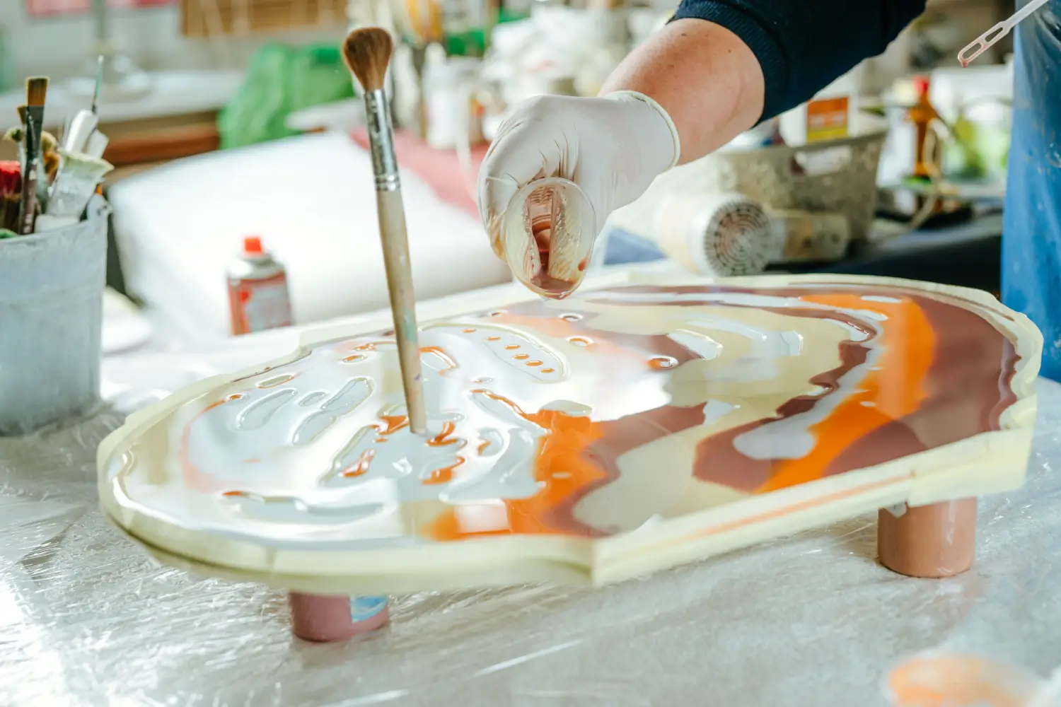 Resin art, pouring colorful resin into mold.