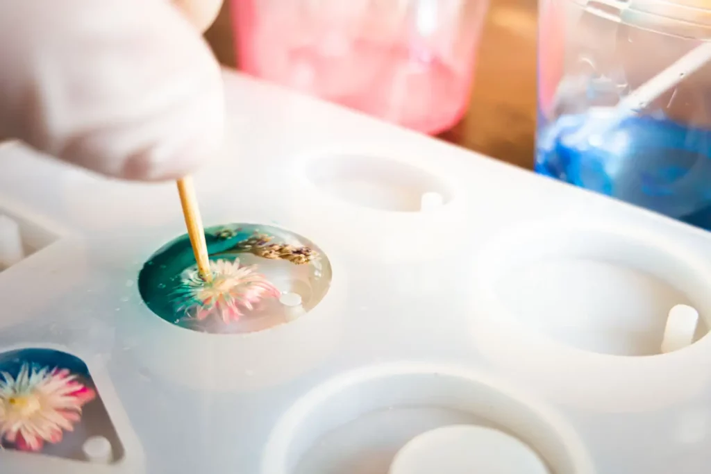 Close-up of resin crafting. Flowers in resin mold.