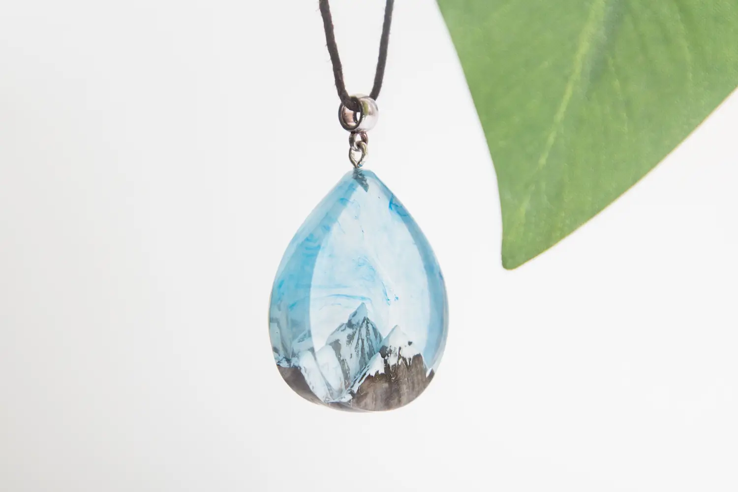 Teardrop-shaped resin pendant, mountain scene, blue, necklace.