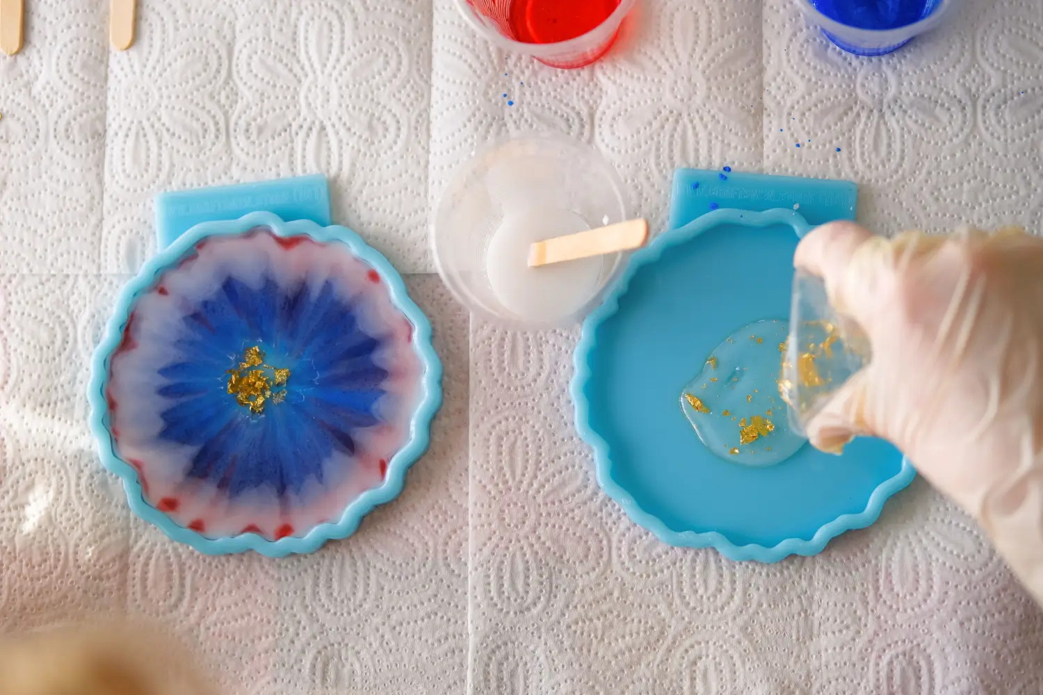 Resin art, mixing colorful resin with gold leaf in silicone molds.