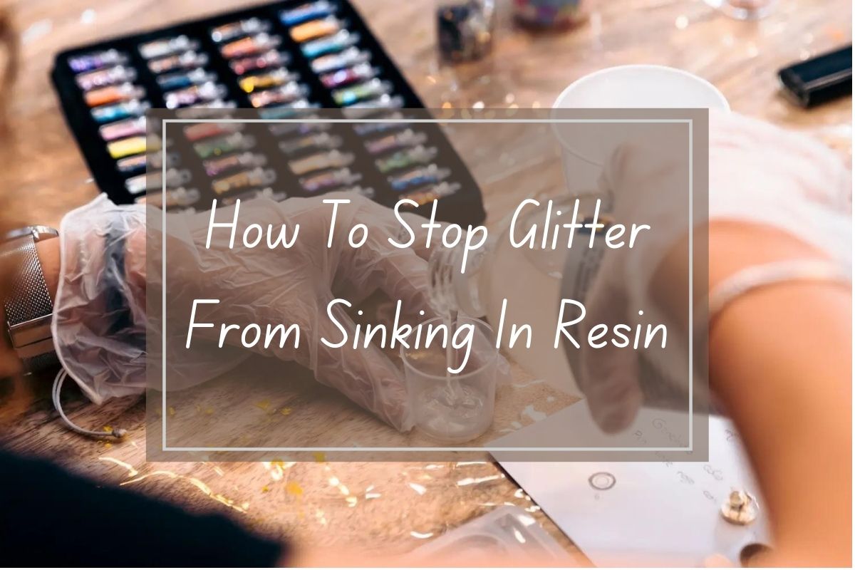 Hands in gloves, adding glitter to resin, preventing sinking.