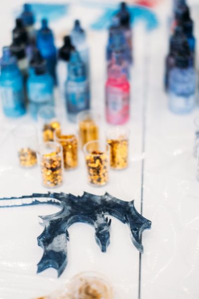 Dark blue resin dragon figurine, craft supplies, gold glitter.